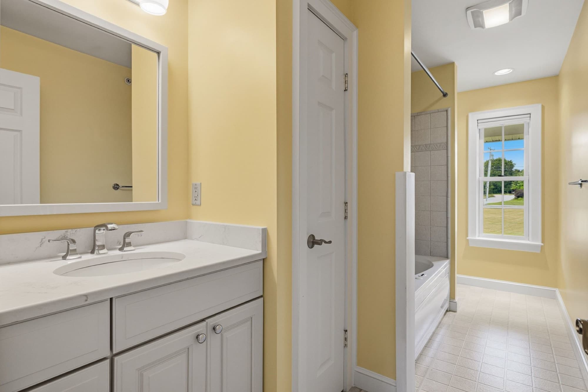 The guest bath with the vanity and the tub and shower